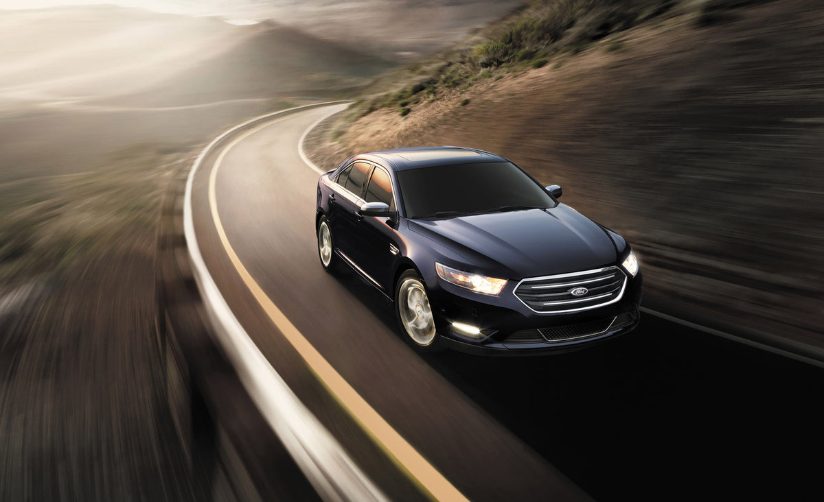 This archival image documents the 2015 Ford Taurus action shot on scenic road and is preserved in the Ford Heritage Vault as part of Ford Motor Company's historic photographic archive. Free for personal, non-commercial use. Ford Heritage Vault ref...