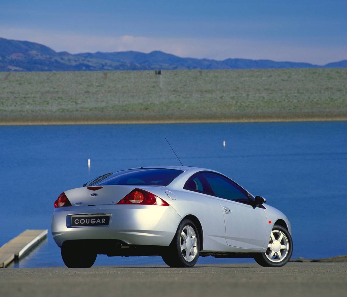 This archival image documents the 1998 Ford Cougar rear view near scenic body of water AR-2002-213709 and is preserved in the Ford Heritage Vault as part of Ford Motor Company's historic photographic archive. Free for personal, non-commercial use....