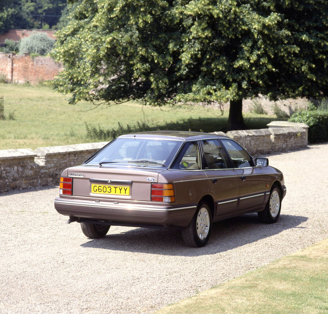 This archival image documents the 1989 Ford Granada Scorpio Mark III rear view on scenic road and is preserved in the Ford Heritage Vault as part of Ford Motor Company's historic photographic archive. Free for personal, non-commercial use. Ford He...