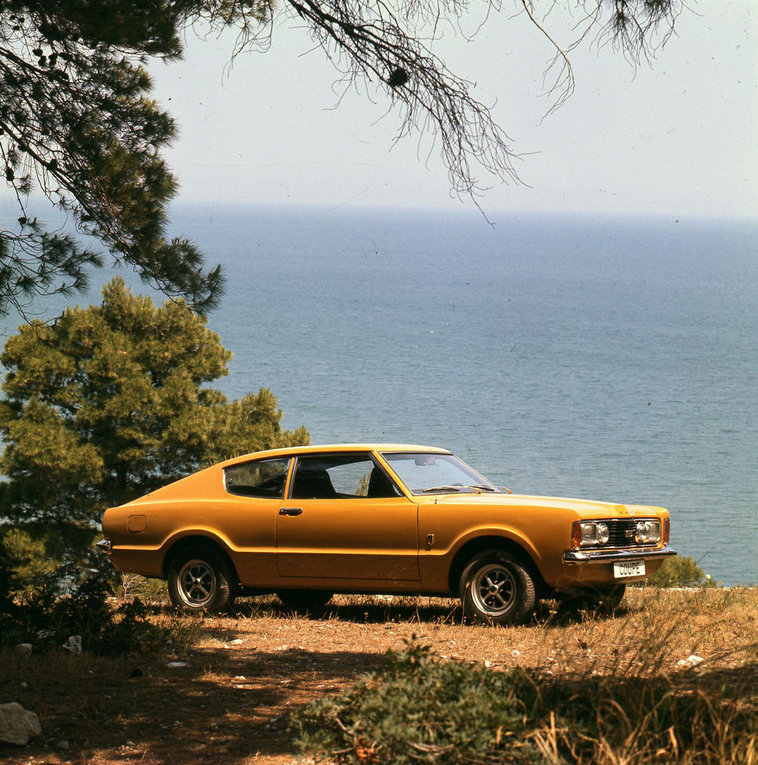 This archival image documents the 1970 Ford Taunus TC on scenic ocean overlook in Italy and is preserved in the Ford Heritage Vault as part of Ford Motor Company's historic photographic archive. Free for personal, non-commercial use. Ford Heritage...