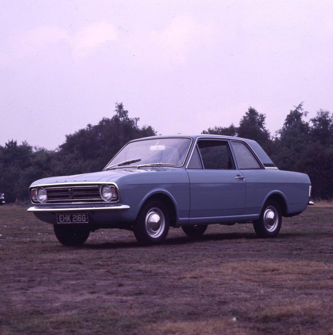 This archival image documents the 1969 Ford Cortina MK II DL 1300 2 door in scenic field with trees and is preserved in the Ford Heritage Vault as part of Ford Motor Company's historic photographic archive. Free for personal, non-commercial use. F...