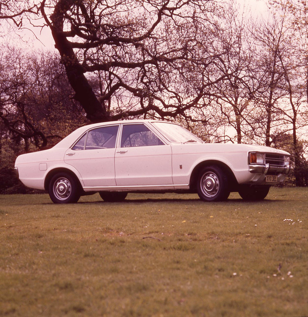 This archival image documents the 1973 Ford Consul L in scenic field with trees and is preserved in the Ford Heritage Vault as part of Ford Motor Company's historic photographic archive. Free for personal, non-commercial use. Ford Heritage Vault r...