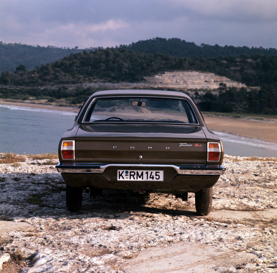 This archival image documents the 1970 Ford Taunus L rear view on scenic rocky beach and is preserved in the Ford Heritage Vault as part of Ford Motor Company's historic photographic archive. Free for personal, non-commercial use. Ford Heritage Va...