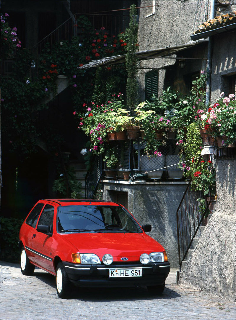 This archival image documents the 1988 Ford Fiesta Mark III LHD with scenic potted flowers and is preserved in the Ford Heritage Vault as part of Ford Motor Company's historic photographic archive. Free for personal, non-commercial use. Ford Herit...