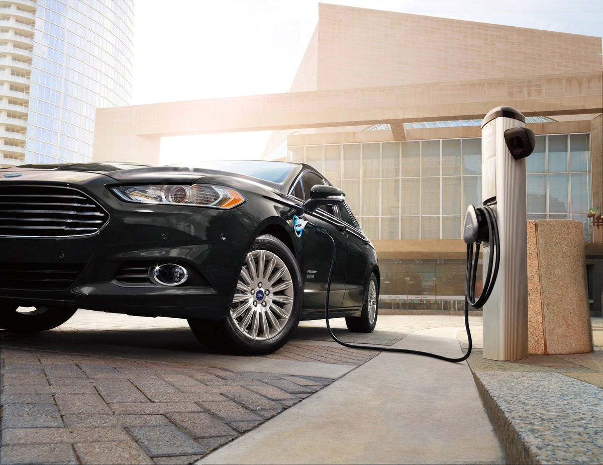 This archival image documents the 2015 Ford Fusion Energi at charger and is preserved in the Ford Heritage Vault as part of Ford Motor Company's historic photographic archive. Free for personal, non-commercial use. Ford Heritage Vault reference AR...
