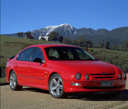 1998 Ford Falcon XR6 on road with scenic mountains HV 1998-0077