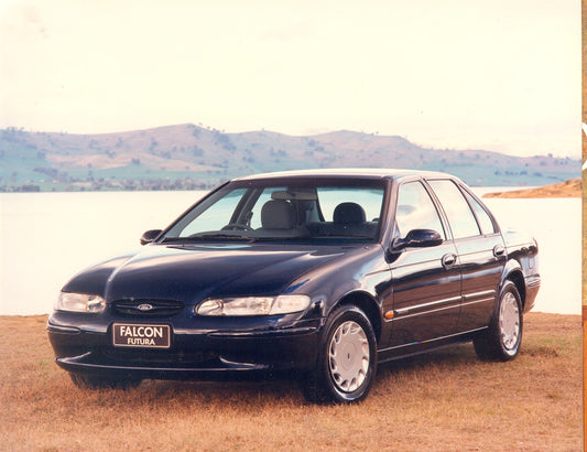 1996 Ford EL Falcon Futura near scenic body of water with mountains HV 1996-0061