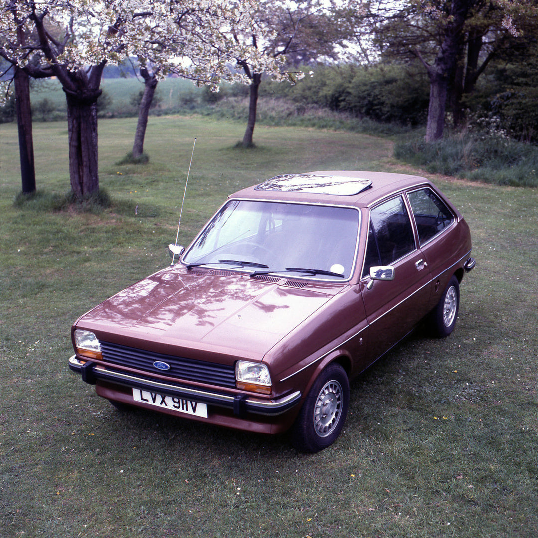 This archival image documents the 1980 Ford Fiesta Mark I Ghia in scenic field with trees and is preserved in the Ford Heritage Vault as part of Ford Motor Company's historic photographic archive. Free for personal, non-commercial use. Ford Herita...