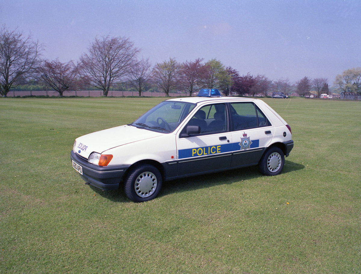 This archival image documents the 1992 Ford Fiesta Mark III Police Car in scenic field with trees and is preserved in the Ford Heritage Vault as part of Ford Motor Company's historic photographic archive. Free for personal, non-commercial use. For...