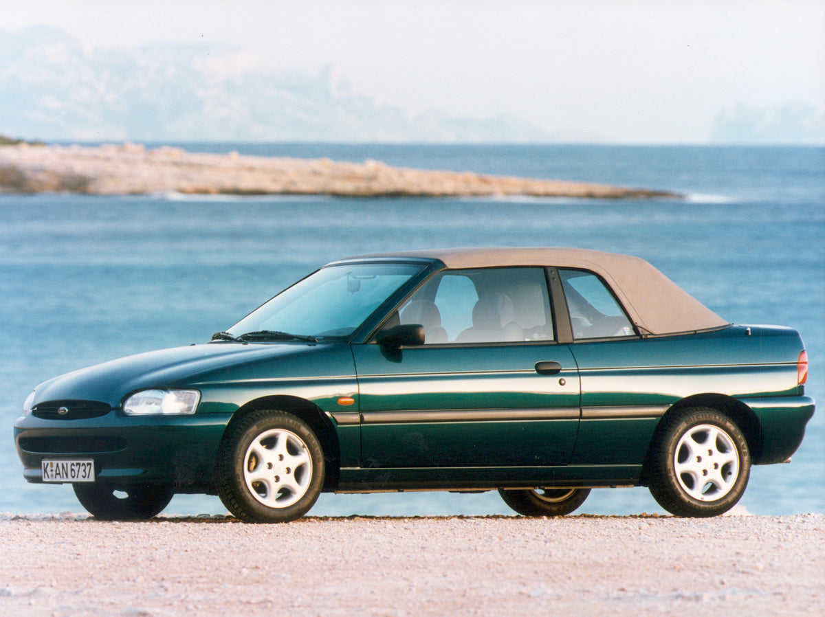 This archival image documents the 1995 Ford Escort Mark V Cabriolet on scenic beach and is preserved in the Ford Heritage Vault as part of Ford Motor Company's historic photographic archive. Free for personal, non-commercial use. Ford Heritage Vau...