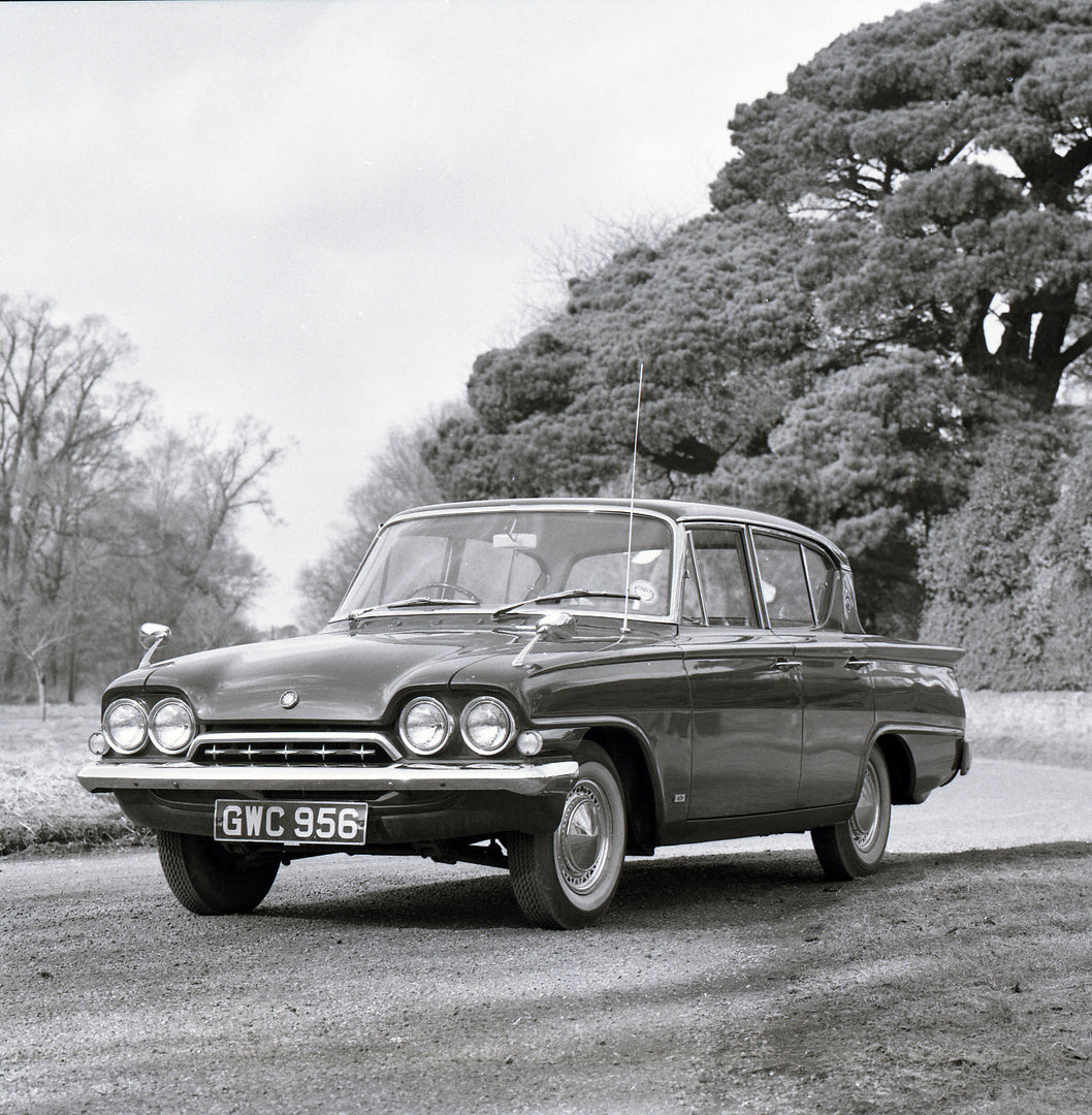 This archival image documents the 1963 Ford Consul 4 Door Classic Deluxe on scenic road with trees and is preserved in the Ford Heritage Vault as part of Ford Motor Company's historic photographic archive. Free for personal, non-commercial use. Fo...