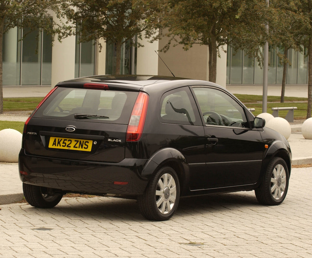 This archival image documents the 2003 Ford Fiesta Mark VI rear view with scenic trees and is preserved in the Ford Heritage Vault as part of Ford Motor Company's historic photographic archive. Free for personal, non-commercial use. Ford Heritage ...
