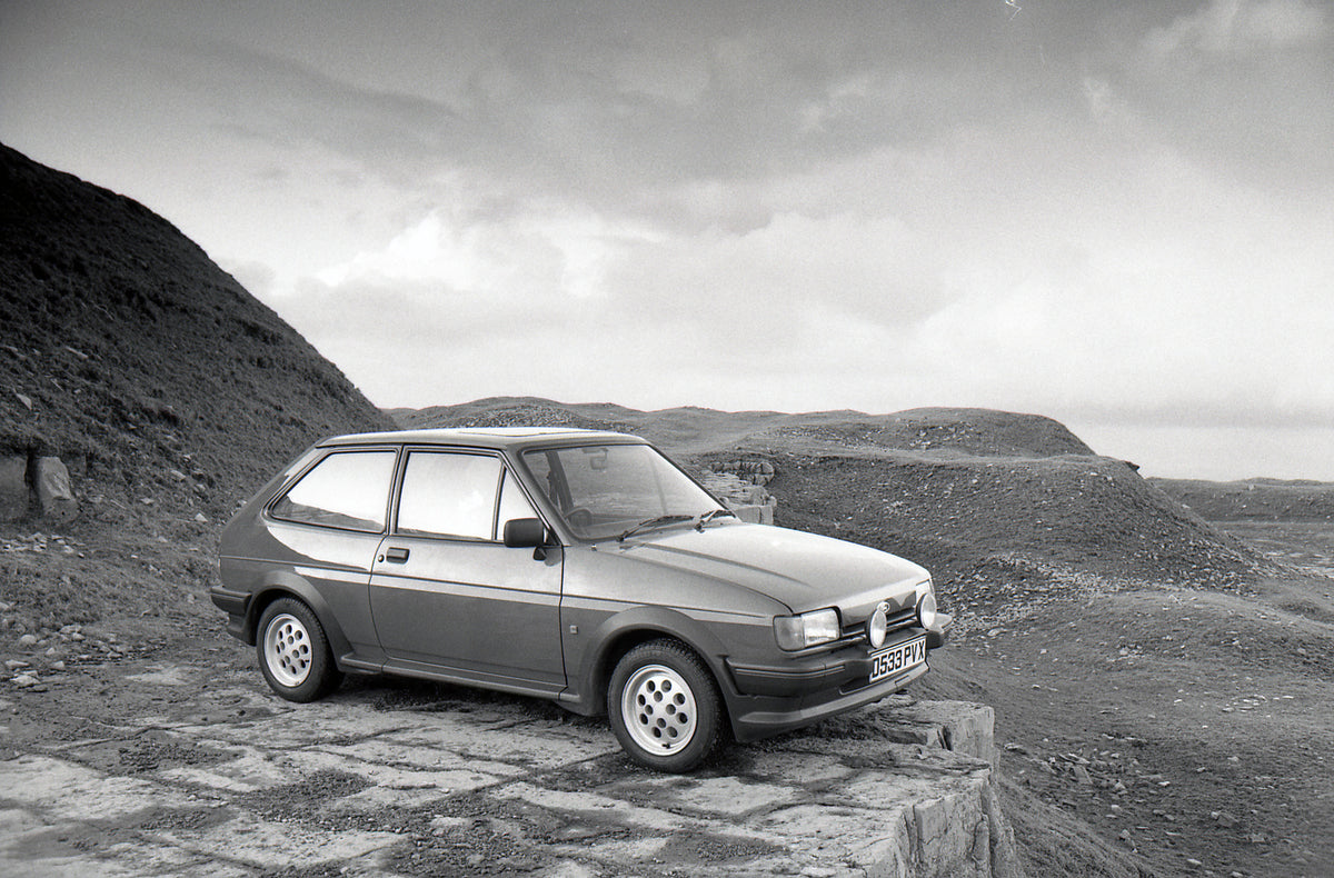 This archival image documents the 1987 Ford Fiesta Mark II XR2 in scenic hilly area and is preserved in the Ford Heritage Vault as part of Ford Motor Company's historic photographic archive. Free for personal, non-commercial use. Ford Heritage Vau...