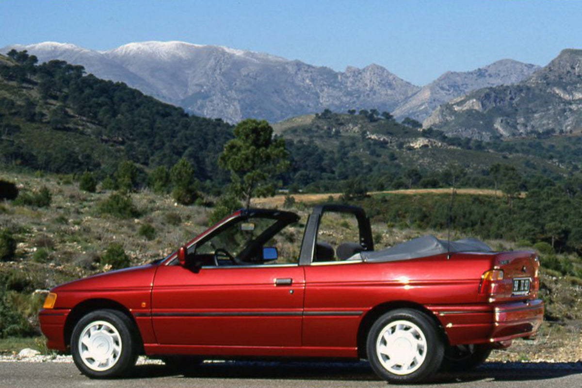This archival image documents the 1990 Ford Escort CE-14 LHD near mountains in Spain and is preserved in the Ford Heritage Vault as part of Ford Motor Company's historic photographic archive. Free for personal, non-commercial use. Ford Heritage Va...