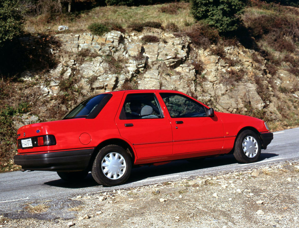This archival image documents the 1990 Ford Sierra 90.5 LHD rear view on scenic road in Spain and is preserved in the Ford Heritage Vault as part of Ford Motor Company's historic photographic archive. Free for personal, non-commercial use. Ford He...