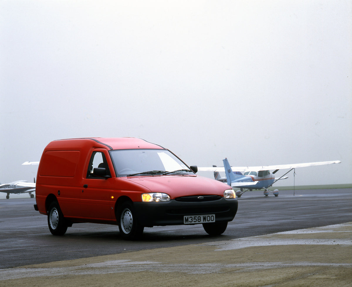 This archival image documents the 1995 Ford Escort Mark V Van on tarmac with plane and is preserved in the Ford Heritage Vault as part of Ford Motor Company's historic photographic archive. Free for personal, non-commercial use. Ford Heritage Vaul...