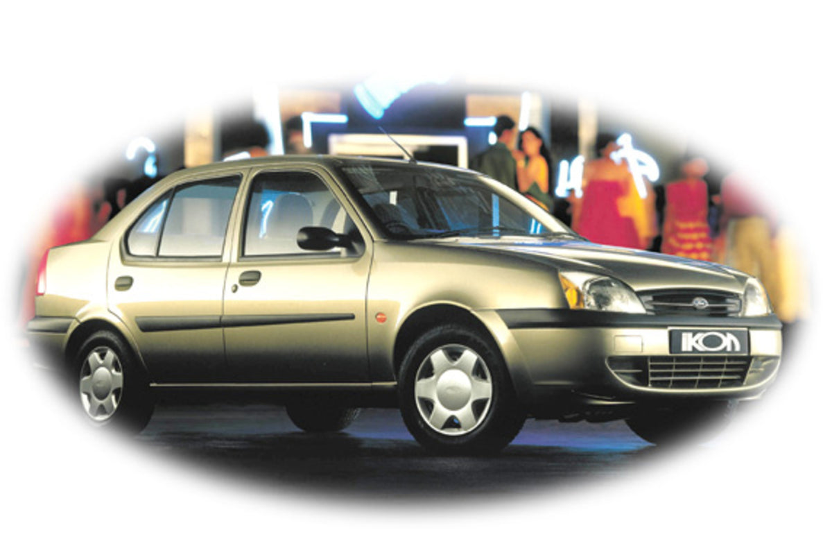 This archival image documents the 2000 Ford Ikon with blurred people at night and is preserved in the Ford Heritage Vault as part of Ford Motor Company's historic photographic archive. Free for personal, non-commercial use. Ford Heritage Vault ref...