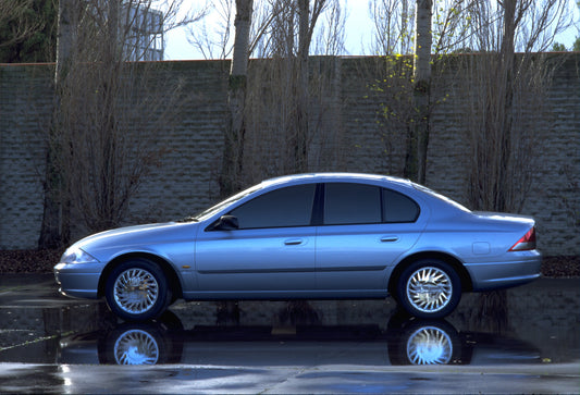 1998 Ford Falcon side view with scenic trees and brick wall HV 1998-0088
