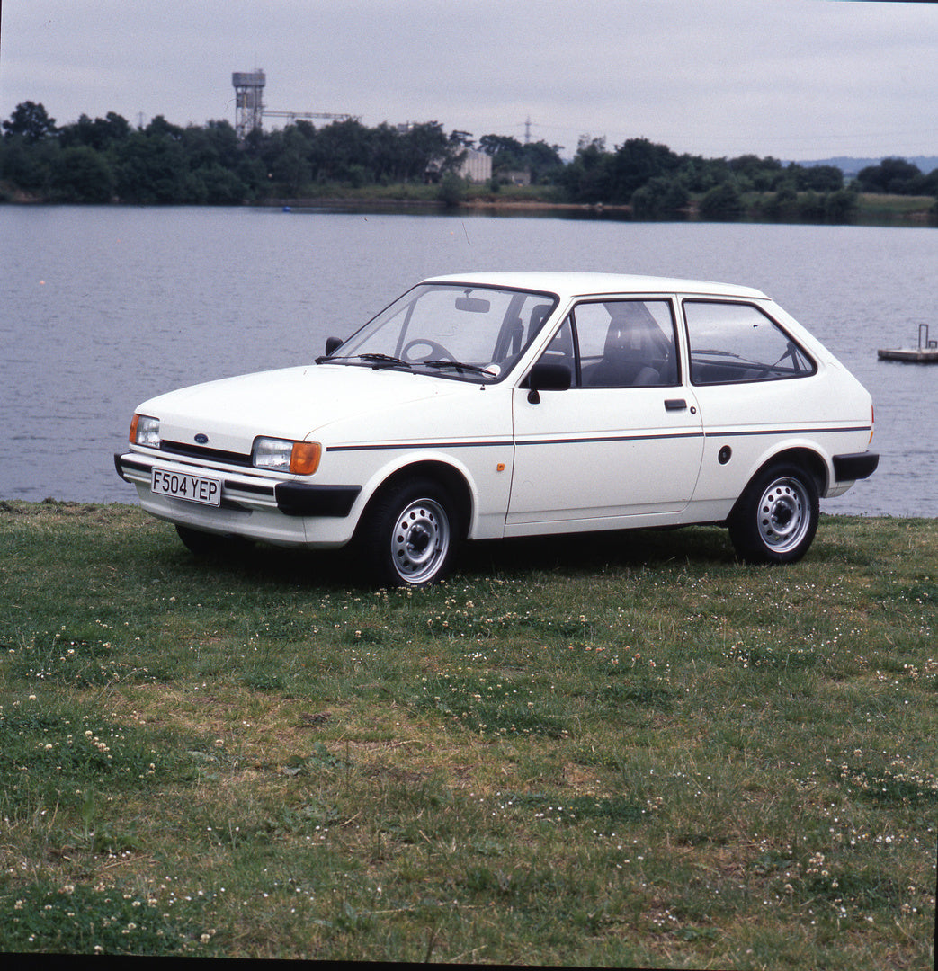 This archival image documents the 1988 Ford Fiesta Mark II Popular Plus 1.1 L in front of scenic lake and is preserved in the Ford Heritage Vault as part of Ford Motor Company's historic photographic archive. Free for personal, non-commercial use....