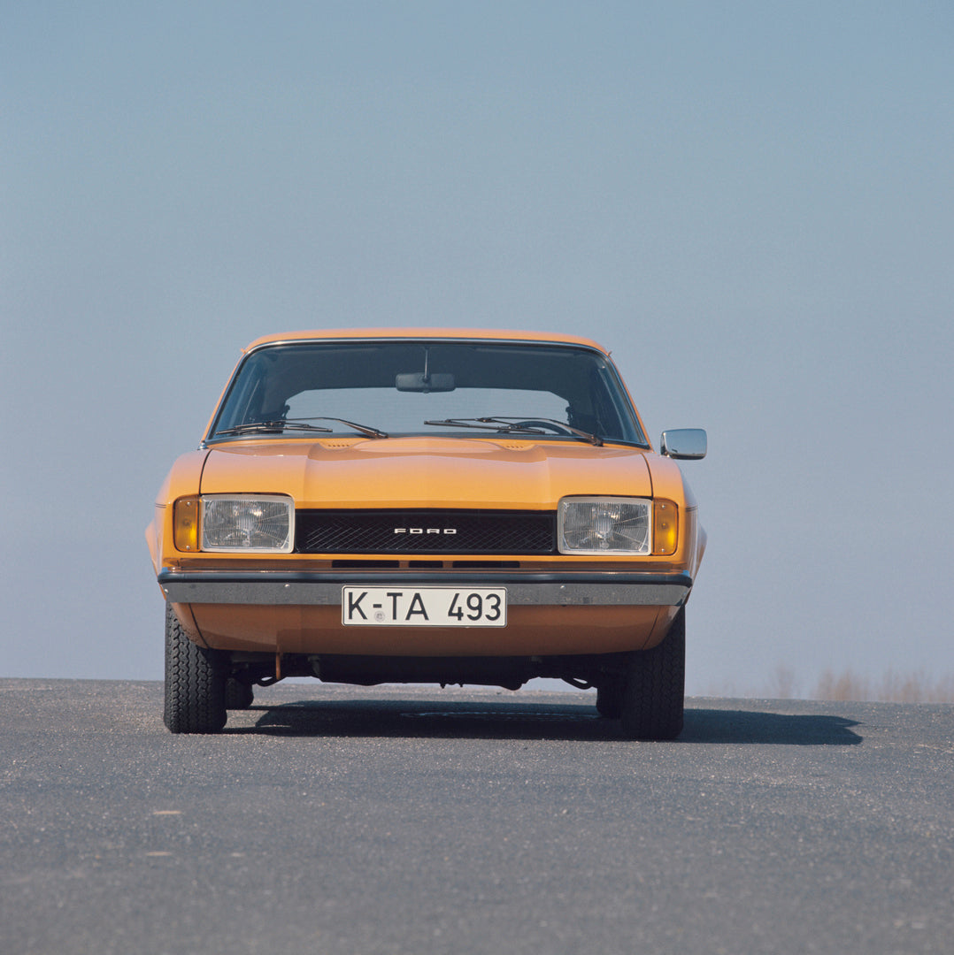 This archival image documents the 1976 Ford Capri II front view with scenic blue sky and is preserved in the Ford Heritage Vault as part of Ford Motor Company's historic photographic archive. Free for personal, non-commercial use. Ford Heritage Va...