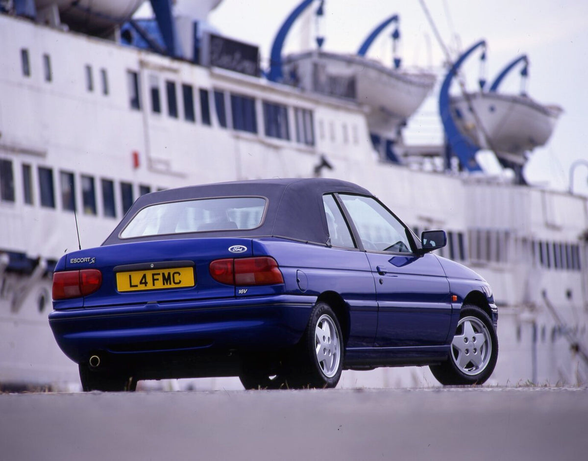 This archival image documents the 1993 Ford Escort Mark V Cabriolet rear view with boat and is preserved in the Ford Heritage Vault as part of Ford Motor Company's historic photographic archive. Free for personal, non-commercial use. Ford Heritage...