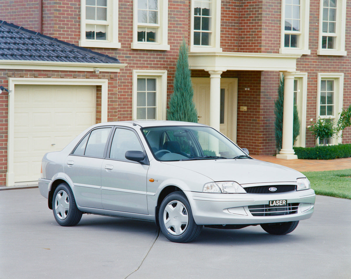 This archival image documents the 1999 Ford KN Laser Sedan Driver Side Front End View in Driveway FAP-2011-3 and is preserved in the Ford Heritage Vault as part of Ford Motor Company's historic photographic archive. Free for personal, non-commerci...