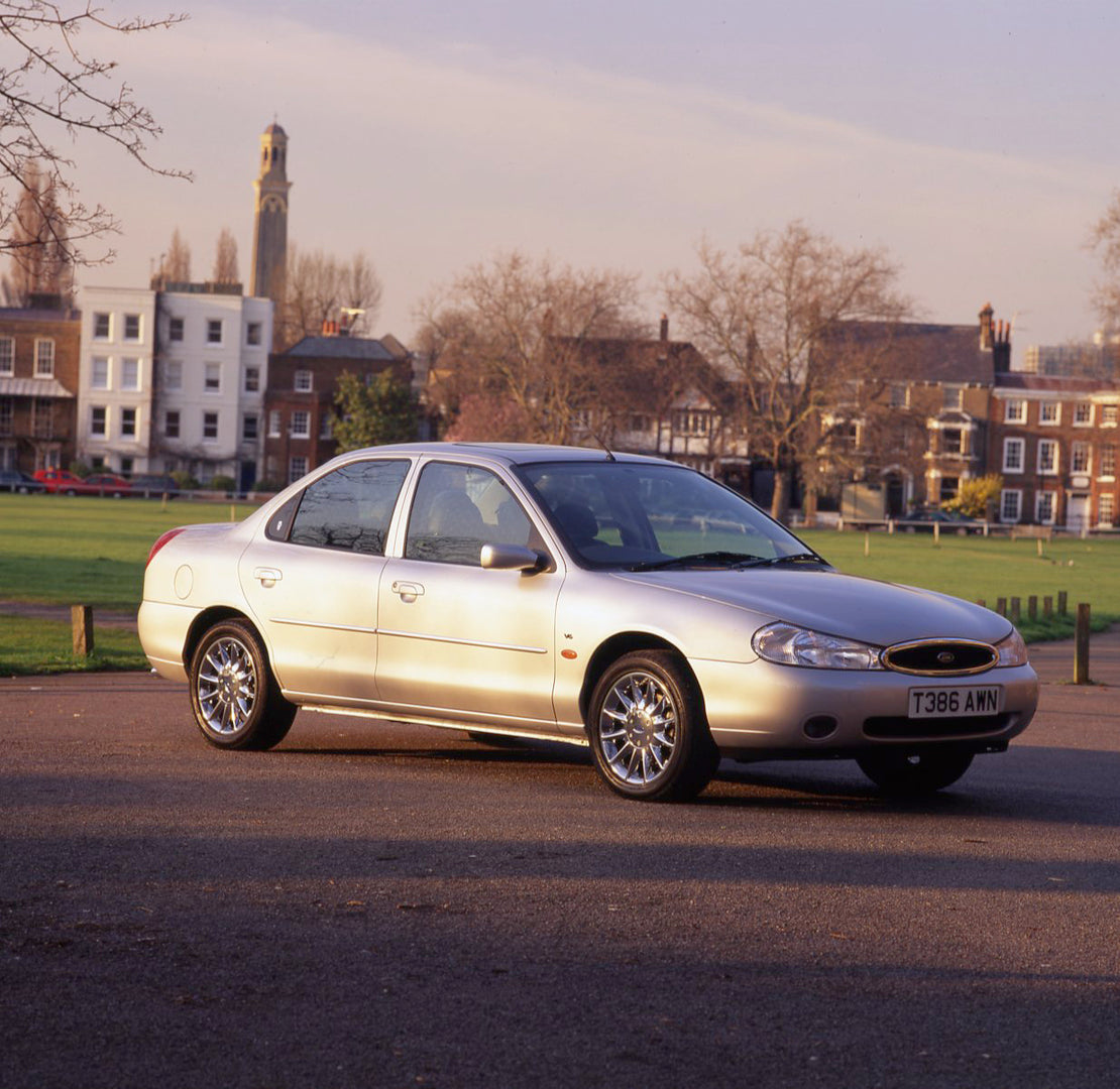 This archival image documents the 1999 Ford Mondeo Mark I Ghia X with scenic houses and is preserved in the Ford Heritage Vault as part of Ford Motor Company's historic photographic archive. Free for personal, non-commercial use. Ford Heritage Vau...