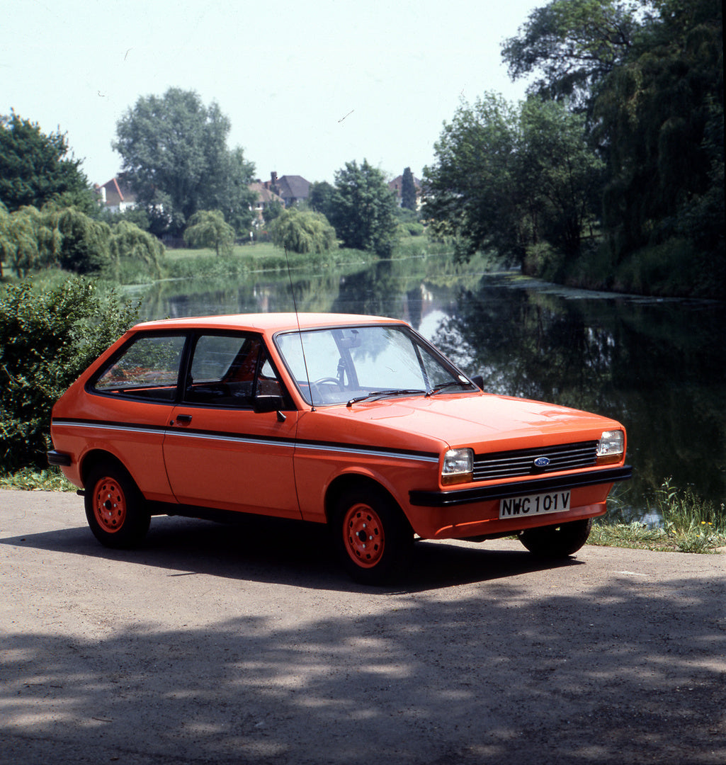 This archival image documents the 1980 Ford Fiesta Mark I Firefly in front of scenic river with trees and is preserved in the Ford Heritage Vault as part of Ford Motor Company's historic photographic archive. Free for personal, non-commercial use....