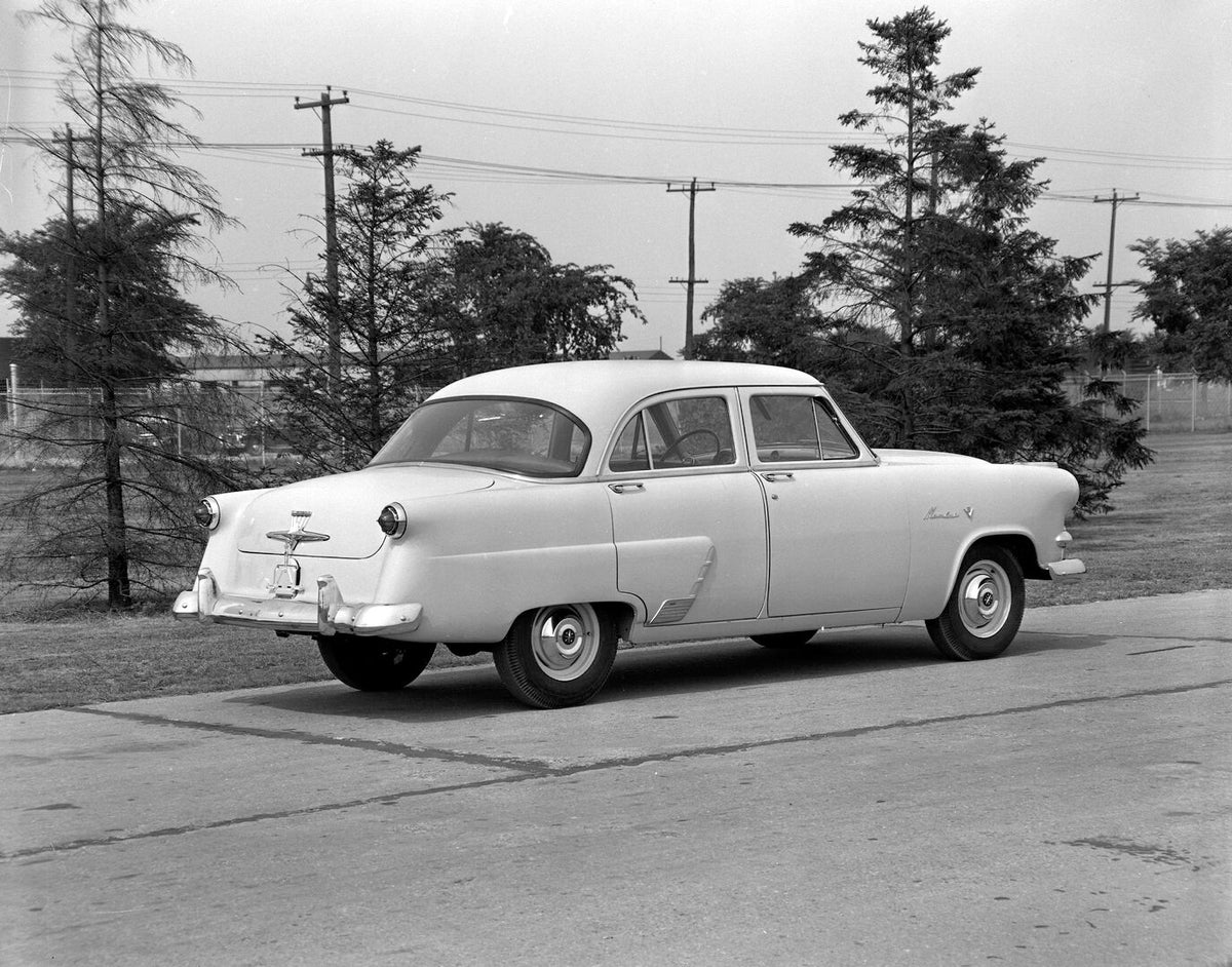 This archival image documents the 1953 Meteor Mainline Sedan rear view on scenic road AR-2007-5 and is preserved in the Ford Heritage Vault as part of Ford Motor Company's historic photographic archive. Free for personal, non-commercial use. Ford ...