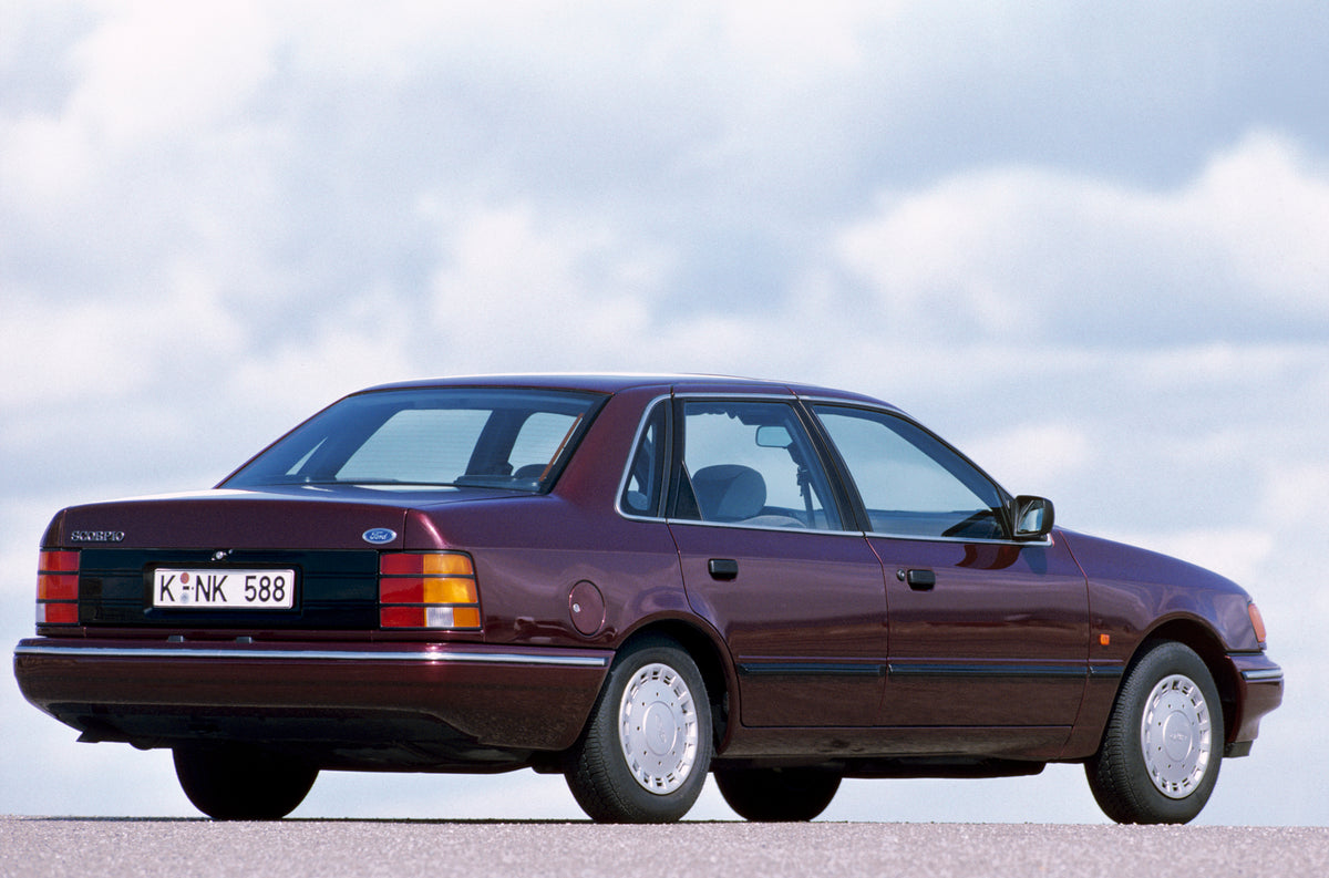 This archival image documents the 1990 Ford Scorpio Mark I rear view with scenic blue sky and is preserved in the Ford Heritage Vault as part of Ford Motor Company's historic photographic archive. Free for personal, non-commercial use. Ford Herita...