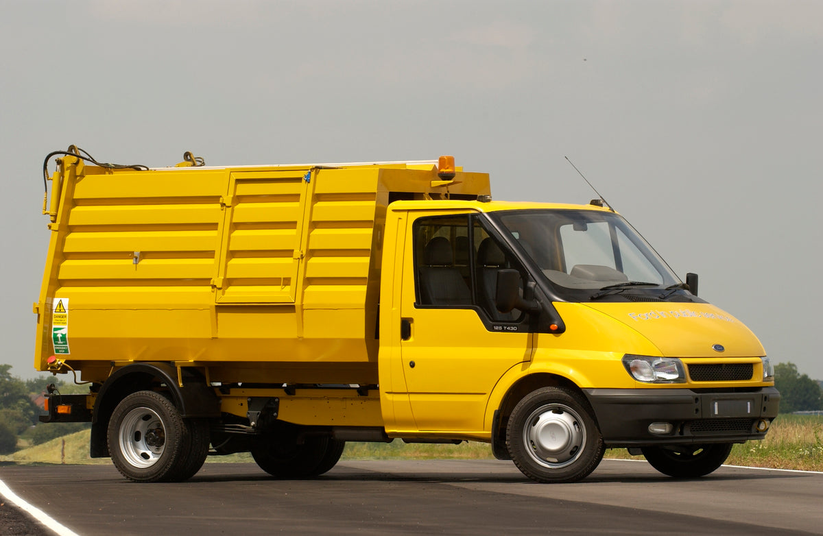 This archival image documents the 2003 Ford Transit Mark IV conversion garbage truck on scenic road and is preserved in the Ford Heritage Vault as part of Ford Motor Company's historic photographic archive. Free for personal, non-commercial use. F...