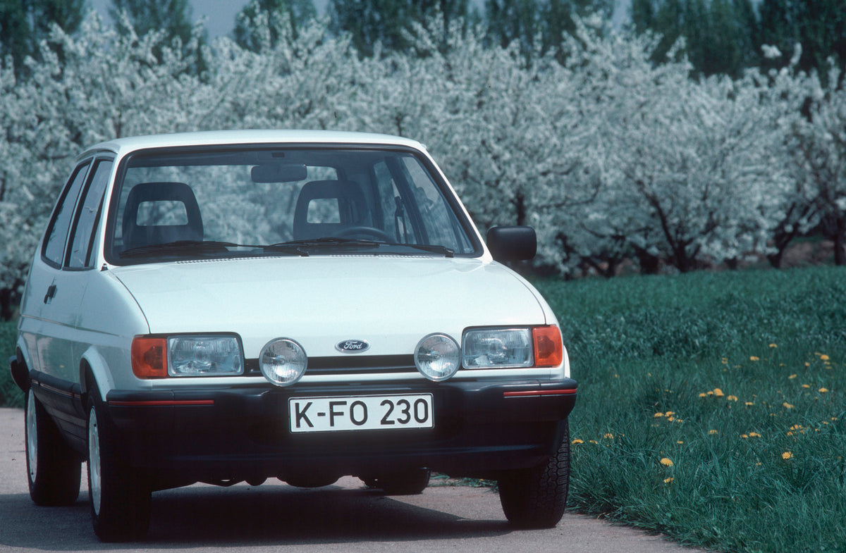 This archival image documents the 1987 Ford Fiesta Mark II Super front view on scenic road and is preserved in the Ford Heritage Vault as part of Ford Motor Company's historic photographic archive. Free for personal, non-commercial use. Ford Herit...
