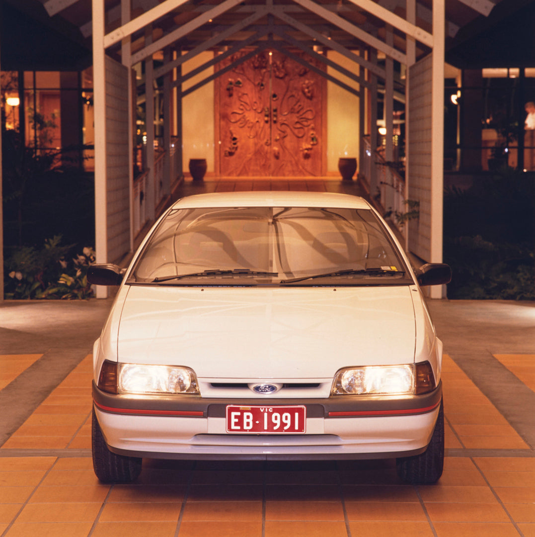This archival image documents the 1991 Ford EB Falcon S Sedan Front End View in Driveway FAP-2011-3 and is preserved in the Ford Heritage Vault as part of Ford Motor Company's historic photographic archive. Free for personal, non-commercial use. F...