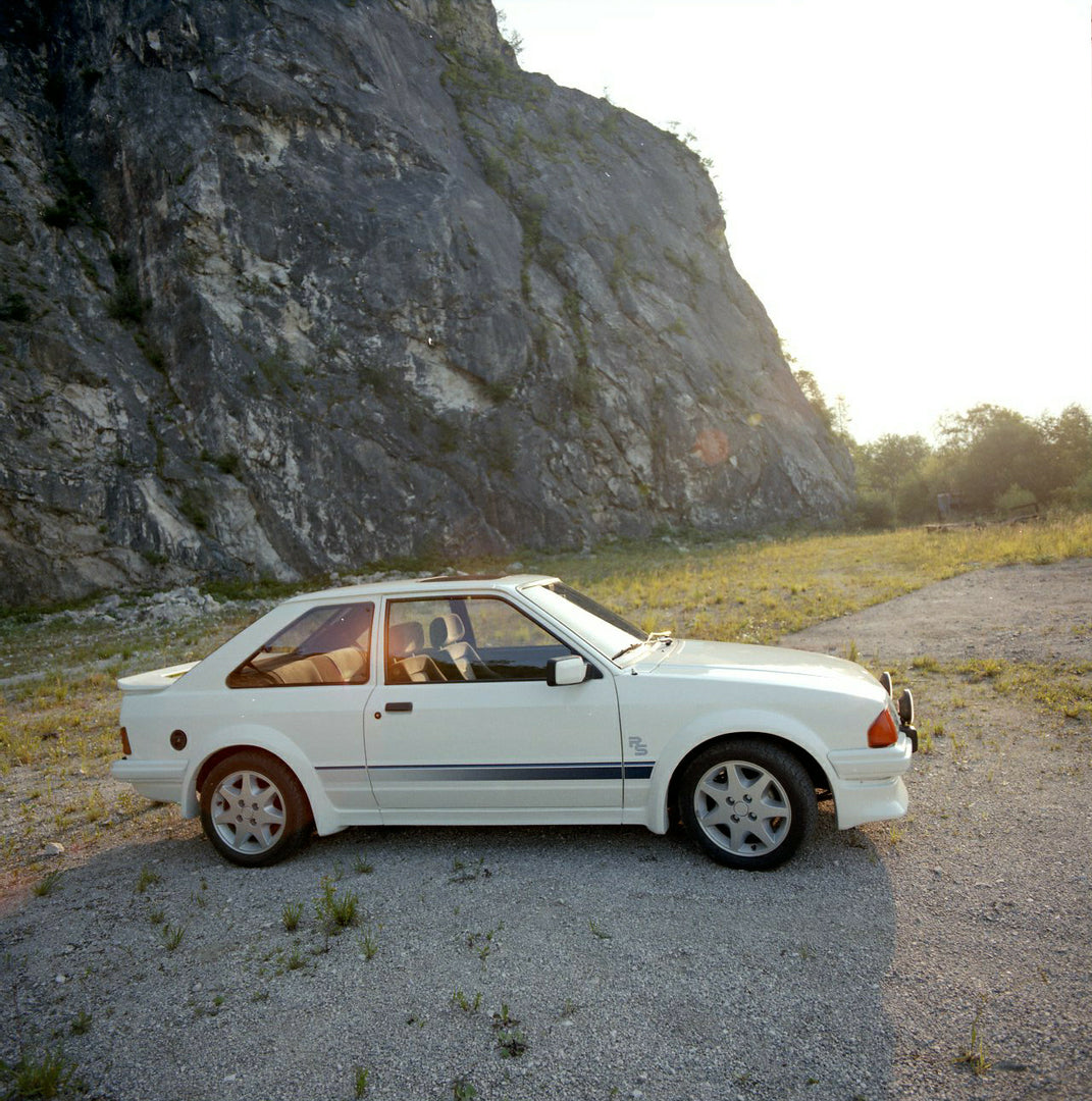 This archival image documents the 1984 Ford Escort Mark III LHD RS Turbo side view with scenic rock formation in Munich and is preserved in the Ford Heritage Vault as part of Ford Motor Company's historic photographic archive. Free for personal, n...
