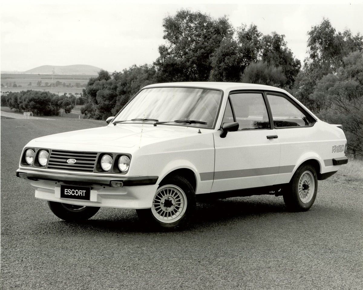 This archival image documents the 1979 Escort Mark II RS2000 on scenic road with trees and is preserved in the Ford Heritage Vault as part of Ford Motor Company's historic photographic archive. Free for personal, non-commercial use. Ford Heritage ...