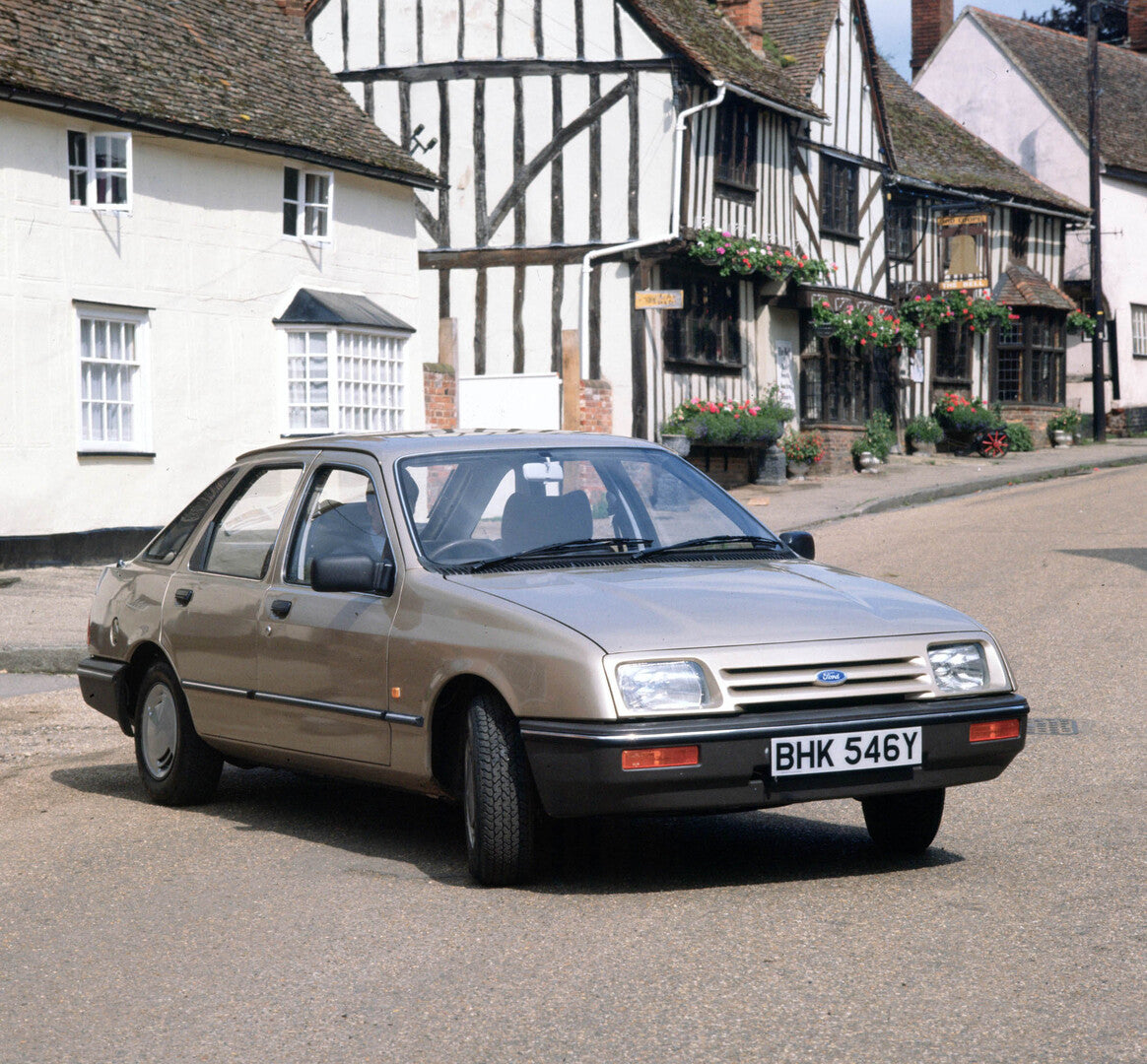 This archival image documents the 1982 Ford Sierra GL on scenic street with historical buildings and is preserved in the Ford Heritage Vault as part of Ford Motor Company's historic photographic archive. Free for personal, non-commercial use. Ford...