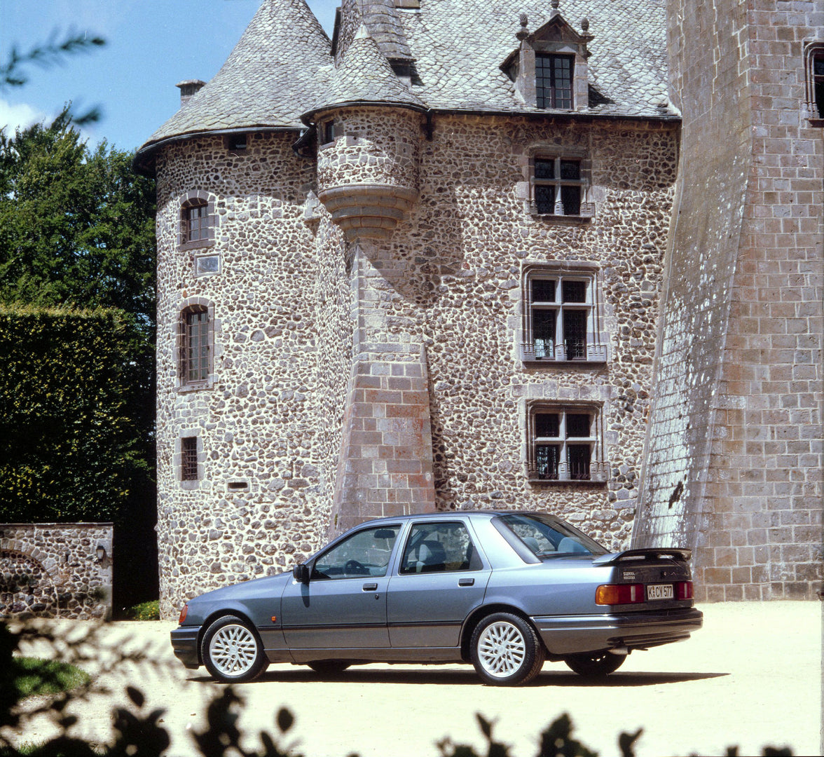 This archival image documents the 1987 Ford Sierra RS Cosworth rear view in front of scenic castle in France and is preserved in the Ford Heritage Vault as part of Ford Motor Company's historic photographic archive. Free for personal, non-commerci...