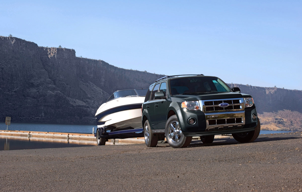 This archival image documents the 2010 Ford Escape towing boat scenic lake and is preserved in the Ford Heritage Vault as part of Ford Motor Company's historic photographic archive. Free for personal, non-commercial use. Ford Heritage Vault refere...