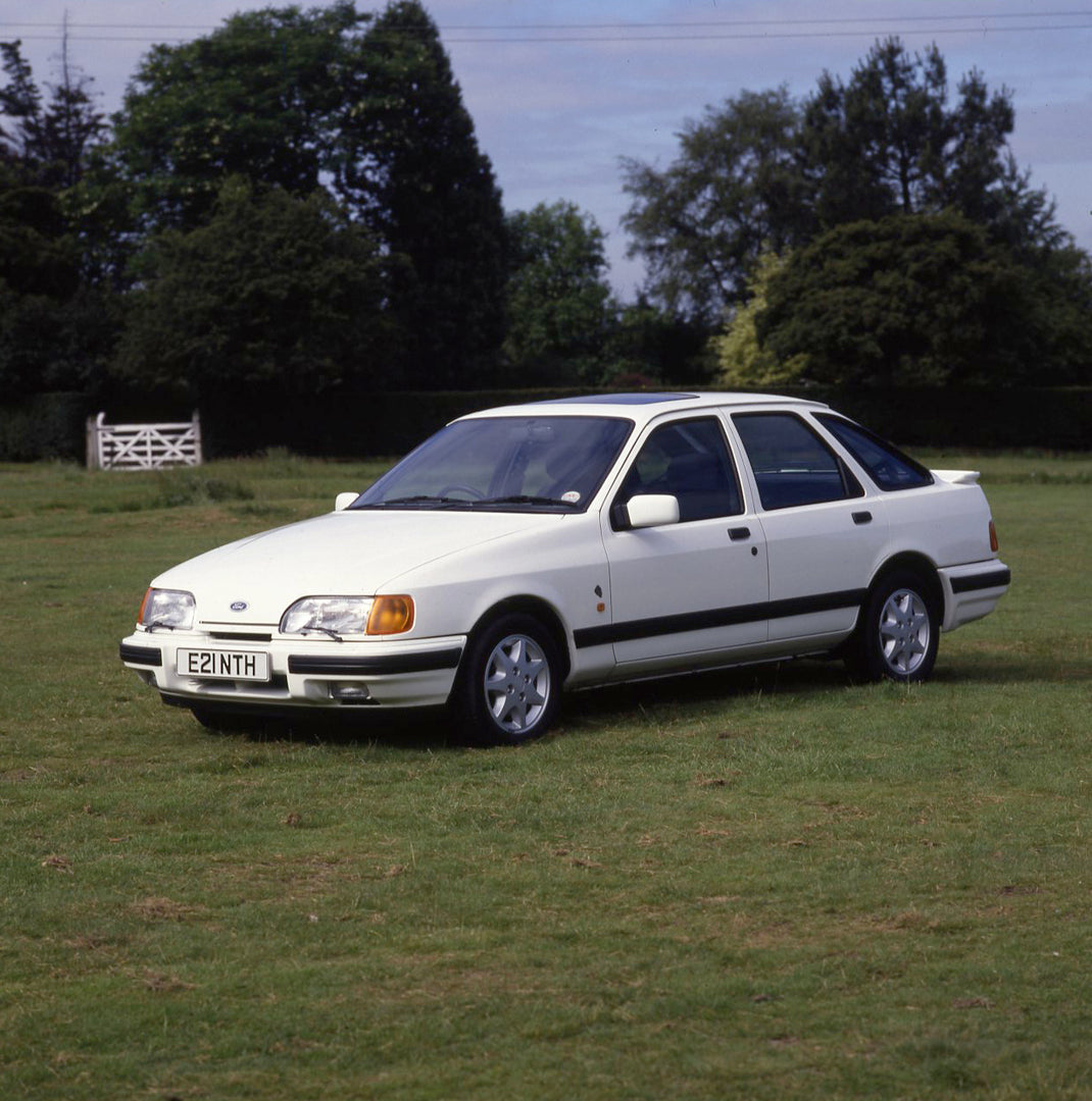 This archival image documents the 1987 Ford Sierra Mark II XR 4x4 in scenic field with trees and is preserved in the Ford Heritage Vault as part of Ford Motor Company's historic photographic archive. Free for personal, non-commercial use. Ford Her...