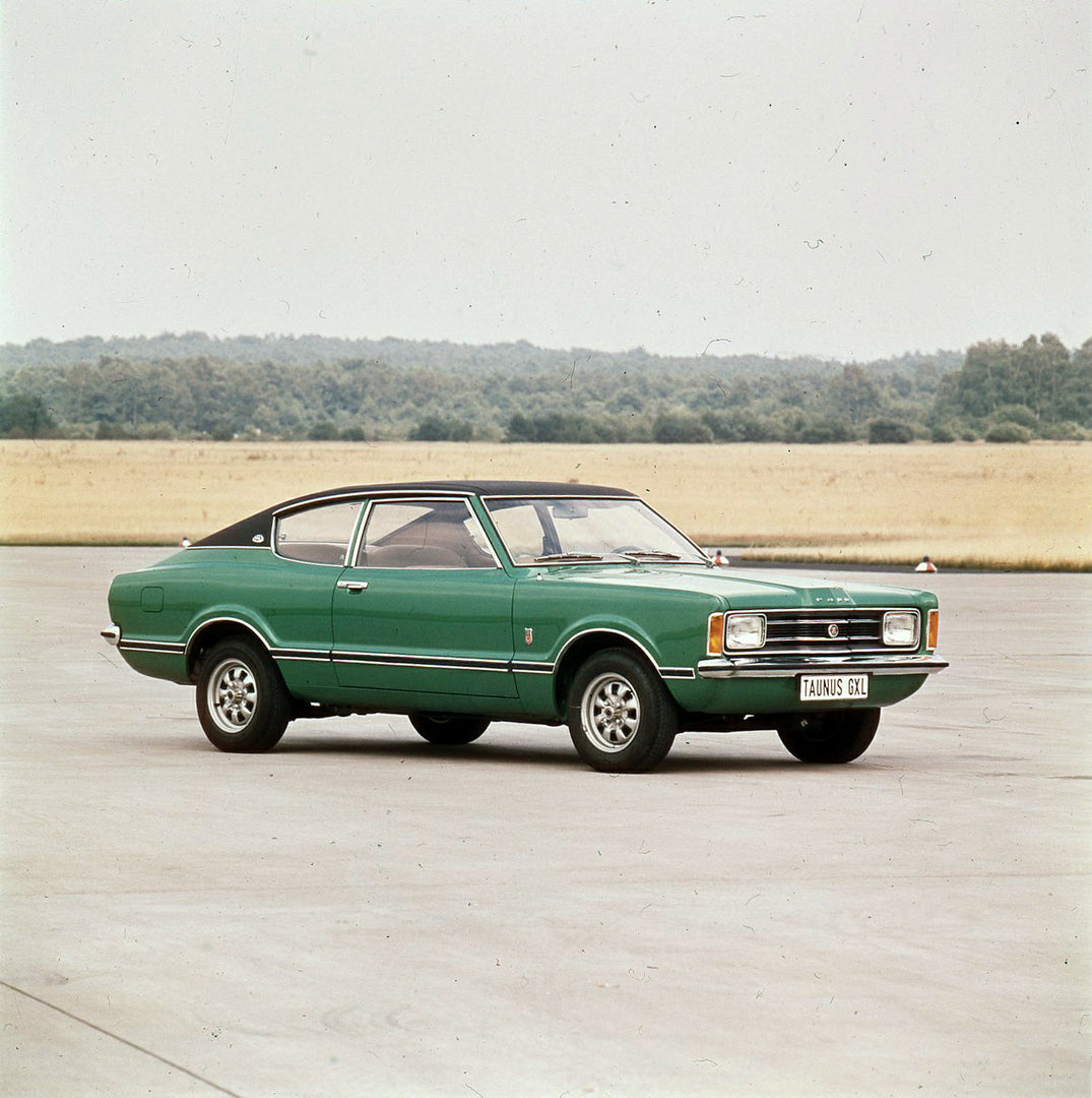This archival image documents the 1974 Ford Taunus GXL with scenic trees and is preserved in the Ford Heritage Vault as part of Ford Motor Company's historic photographic archive. Free for personal, non-commercial use. Ford Heritage Vault referenc...