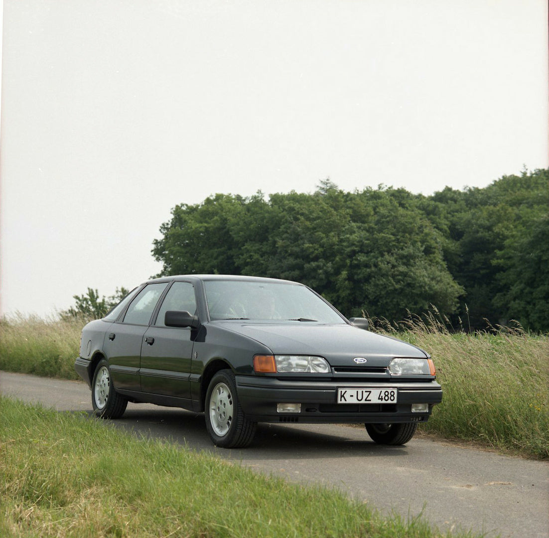 This archival image documents the 1985 Ford Scorpio Mark I 4 Wheel Drive LHD on scenic road with trees and is preserved in the Ford Heritage Vault as part of Ford Motor Company's historic photographic archive. Free for personal, non-commercial use...