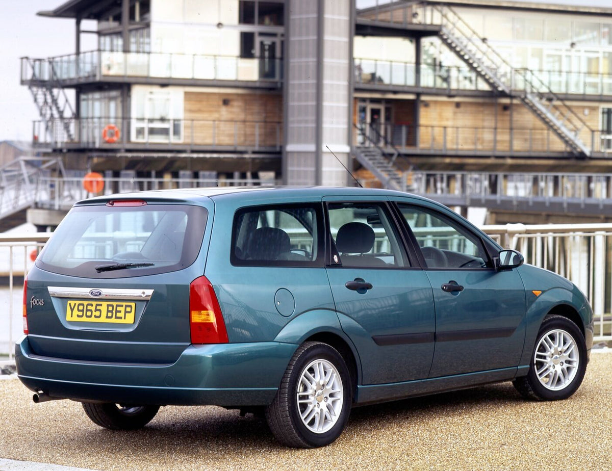 This archival image documents the 2001 Ford Focus Mark I Estate rear view in front of ship and is preserved in the Ford Heritage Vault as part of Ford Motor Company's historic photographic archive. Free for personal, non-commercial use. Ford Herit...
