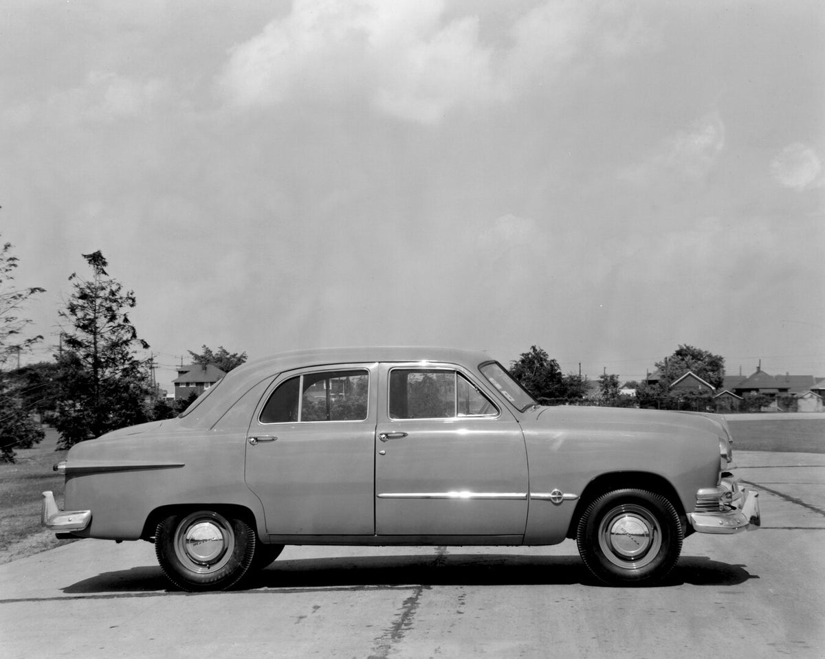 This archival image documents the 1951 Meteor Sedan side view on scenic road with trees AR-2007-5 and is preserved in the Ford Heritage Vault as part of Ford Motor Company's historic photographic archive. Free for personal, non-commercial use. For...