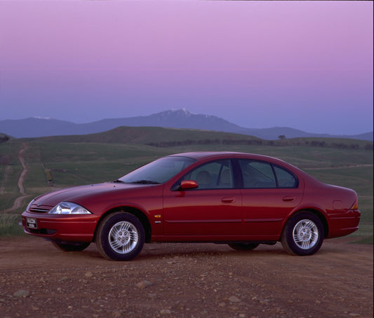 1998 Ford Falcon Futura side view on scenic road with mountains HV 1998-0074
